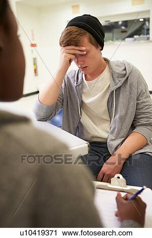 Young Man Talking To Counsellor Who Takes Notes View Large Photo Image Stock Image - Young Man Talking To Counsellor Who Takes Notes. Fotosearch
