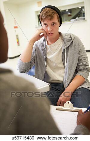 Young Man Talking To Counsellor Who Takes Notes View Large Photo Image Stock Image - Young Man Talking To Counsellor Who Takes Notes. Fotosearch