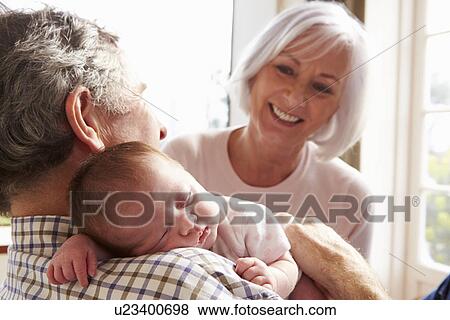 Stock Photo - Young Man With Dog Sit On Sofa Using Digital Tablet. Fotosearch