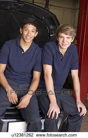 Stock Image - Young mechanics at work. Fotosearch