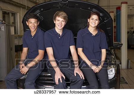 Stock Photo - Young mechanics at work. Fotosearch