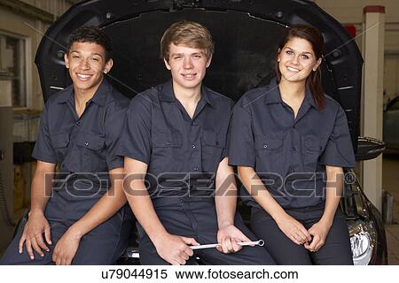 Stock Photography - Young mechanics at work. Fotosearch