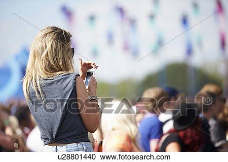 Young Woman At Outdoor Music Festival Using Mobile Phone View Large Photo Image Stock Image - Young Woman At Outdoor Music Festival Using Mobile Phone. Fotosearch