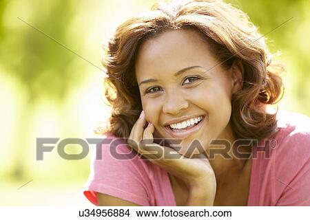 Picture - Young woman portrait outdoors. Fotosearch