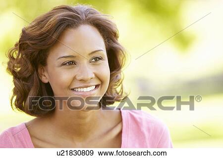 Young woman portrait outdoors View Large Photo Image Stock Photo - Young woman portrait outdoors. Fotosearch