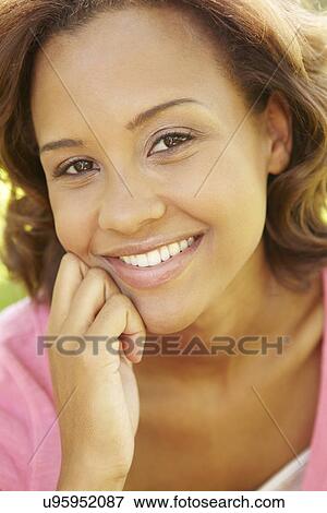 Stock Photo - Young woman portrait outdoors. Fotosearch
