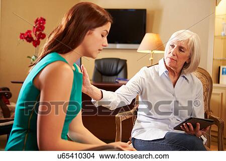 Young Woman Talking To Counsellor Using Digital Tablet View Large Photo Image Picture - Young Woman Talking To Counsellor Using Digital Tablet. Fotosearch