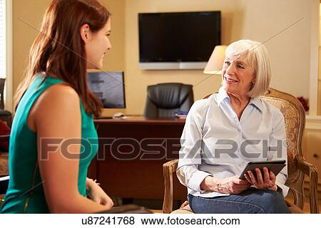 Stock Photo - Young Woman Talking To Counsellor Using Digital Tablet. Fotosearch