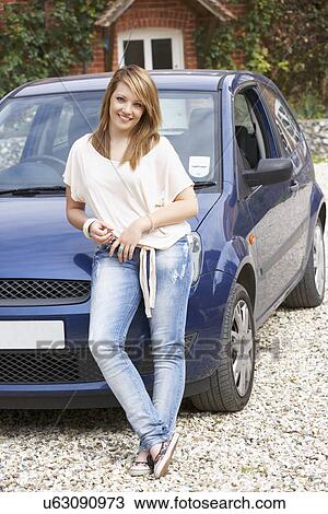 Stock Image - Young woman with car. Fotosearch