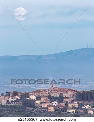 Stock Photo - Full moon over MonteCastello di Vibio, Umbria Italy. Fotosearch