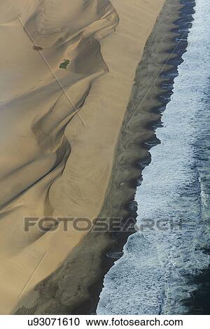 Aerial view of coastline and dunes, Namib Desert, Namibia View Large Photo Image Stock Image - Aerial view of coastline and dunes, Namib Desert, Namibia. Fotosearch