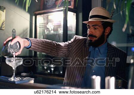 Bartender serving cocktail at bar View Large Photo Image Picture - Bartender serving cocktail at bar. Fotosearch