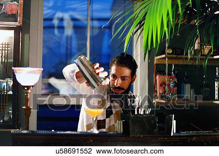 Bartender serving cocktail at bar View Large Photo Image Stock Image - Bartender serving cocktail at bar. Fotosearch