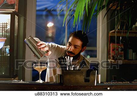 Bartender serving cocktail at bar View Large Photo Image Stock Image - Bartender serving cocktail at bar. Fotosearch