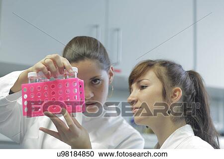 Stock Image - Biology lab technicians having discussion at work. Fotosearch