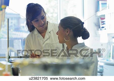 Stock Photography - Biology lab technicians having discussion at work. Fotosearch
