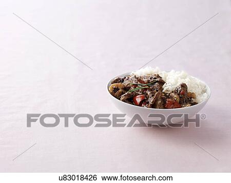 Bowl of wok fried beef in black bean sauce with steamed rice View Large Photo Image Stock Photograph - Bowl of wok fried beef in black bean sauce with steamed rice. Fotosearch