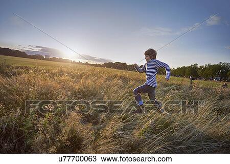 Stock Image - Boy out in the park. Fotosearch