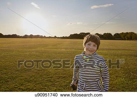 Stock Image - Boy out in the park. Fotosearch