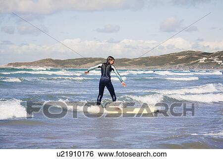 Stock Photograph - Boy surfing. Fotosearch