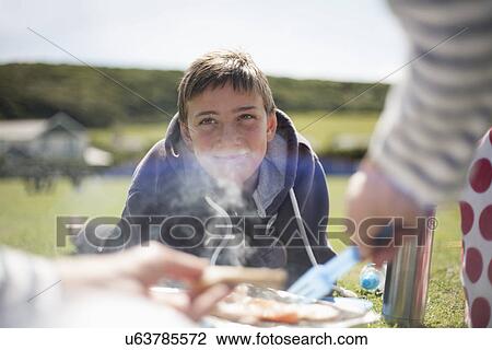 Stock Image - Boy wearing hooded top, smiling. Fotosearch