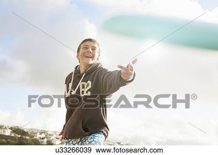 Stock Photo - Boy wearing sweater, smiling. Fotosearch