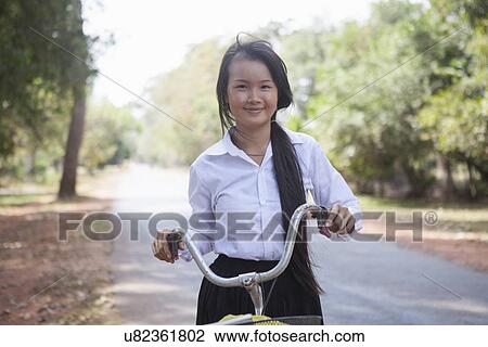 Cambodia girl with her bike on country road, Siem Reap, Cambodia View Large Photo Image Stock Image - Cambodia girl with her bike on country road, Siem Reap, Cambodia. Fotosearch