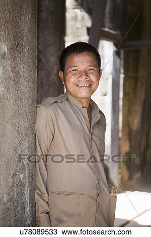 Cambodia man standing by temple, Siem Reap, Cambodia View Large Photo Image Stock Image - Cambodia man standing by temple, Siem Reap, Cambodia. Fotosearch