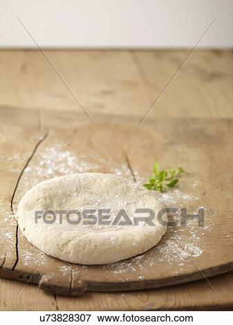 Circle of prepared pizza dough on chopping board sprinkled with flour View Large Photo Image Stock Photo - Circle of prepared pizza dough on chopping board sprinkled with flour. Fotosearch