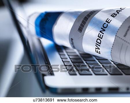 Stock Image - Close up of laptop computer ready to take away in forensic evidence bag. Fotosearch