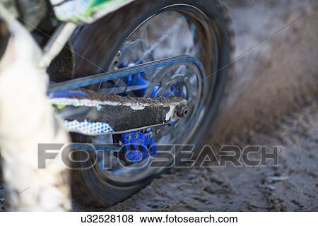 Close up of motocross motorcycle wheel spinning in mud View Large Photo Image Stock Photo - Close up of motocross motorcycle wheel spinning in mud. Fotosearch