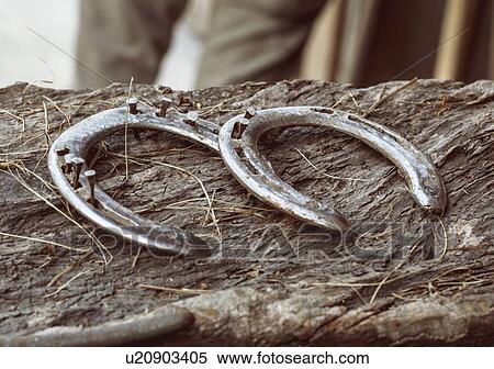 Close up of two worn horse shoes on wood View Large Photo Image Stock Photography - Close up of two worn horse shoes on wood. Fotosearch