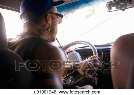 Close up of young man driving on car road trip View Large Photo Image Stock Photograph - Close up of young man driving on car road trip. Fotosearch