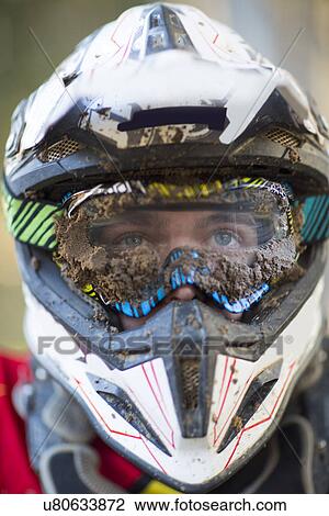 Close up portrait of male motocross racer wearing muddy helmet and goggles View Large Photo Image Stock Image - Close up portrait of male motocross racer wearing muddy helmet and goggles. Fotosearch