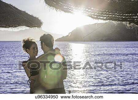 Couple embracing on vacation View Large Photo Image Stock Image - Couple embracing on vacation. Fotosearch
