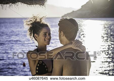 Stock Photography - Couple embracing on vacation. Fotosearch