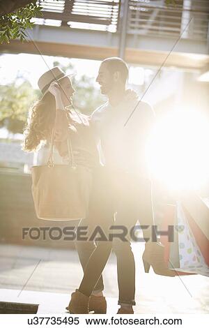Couple, face to face, holding shopping bags View Large Photo Image Stock Photography - Couple, face to face, holding shopping bags. Fotosearch