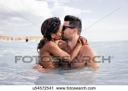 Couple kissing in sea, Tuscany, Italy View Large Photo Image Stock Image - Couple kissing in sea, Tuscany, Italy. Fotosearch