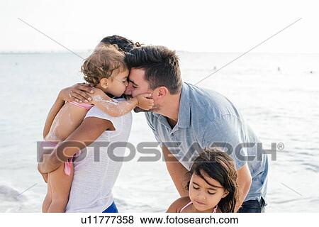 Couple with two girls on beach, Tuscany, Italy View Large Photo Image Stock Photo - Couple with two girls on beach, Tuscany, Italy. Fotosearch