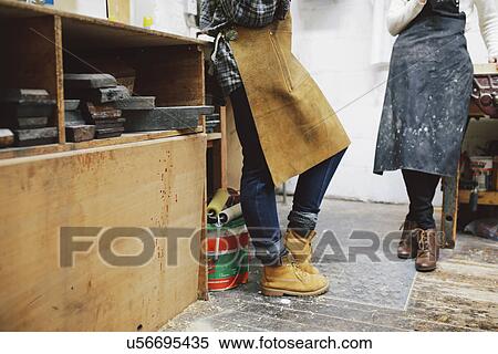 Stock Photography - Cropped view of two young craftswomen in pipe organ workshop. Fotosearch