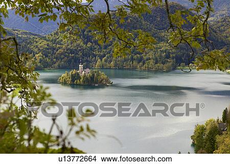 Distant view of church on Bled Island, Lake Bled, Slovenia View Large Photo Image Picture - Distant view of church on Bled Island, Lake Bled, Slovenia. Fotosearch