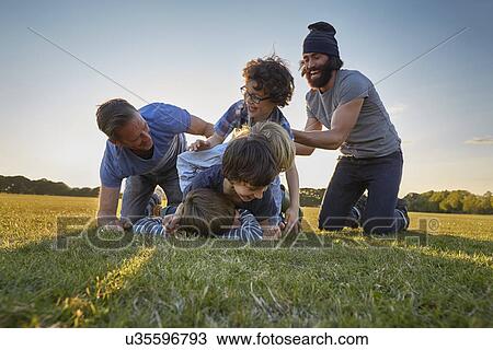 Stock Image - Family enjoying outdoor activities in the park. Fotosearch