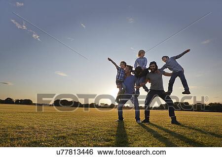 Stock Photograph - Family enjoying outdoor activities in the park. Fotosearch