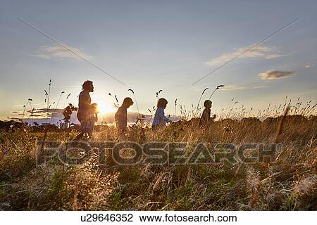 Stock Image - Family out walking in the park. Fotosearch