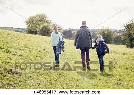Father and daughters walking in field View Large Photo Image Stock Photo - Father and daughters walking in field. Fotosearch