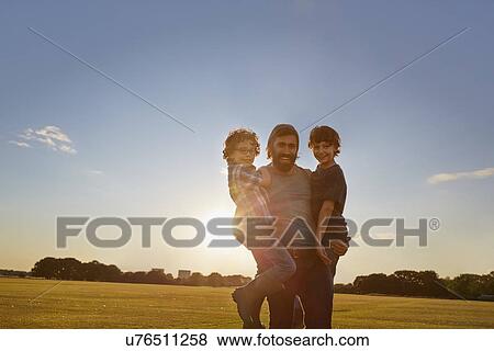 Father and sons out in the park View Large Photo Image Stock Photo - Father and sons out in the park. Fotosearch
