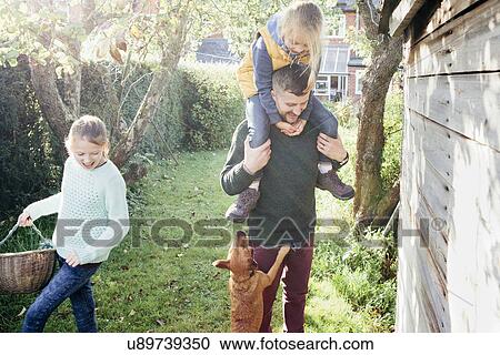 Father with daughter on shoulders in garden View Large Photo Image Stock Image - Father with daughter on shoulders in garden. Fotosearch
