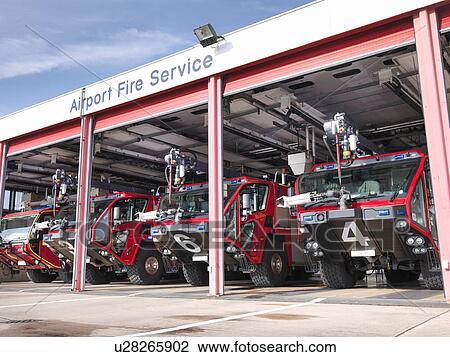 Stock Image - Fire engines in airport fire station. Fotosearch