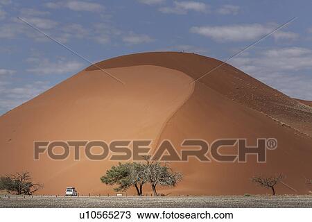Four wheel truck parked at base of giant sand dune, Sossusvlei National Park, Namibia View Large Photo Image Stock Image - Four wheel truck parked at base of giant sand dune, Sossusvlei National Park, Namibia. Fotosearch