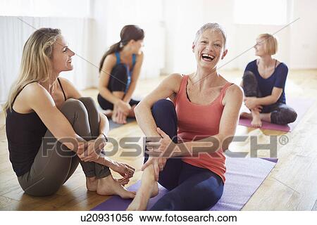Four women sitting on floor in pilates class View Large Photo Image Stock Photograph - Four women sitting on floor in pilates class. Fotosearch